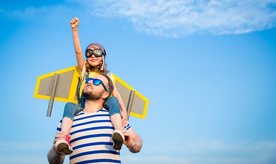 Man holding daughter on his shoulders