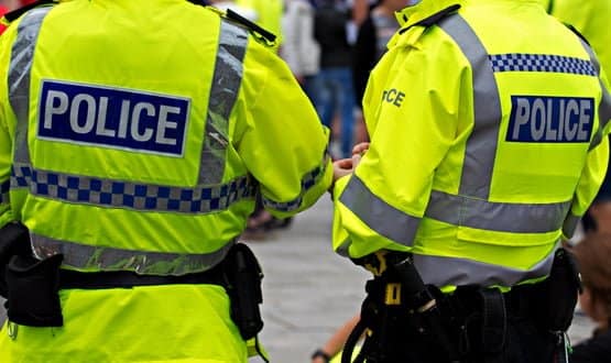 Two police officers on patrol in high-visibility jackets