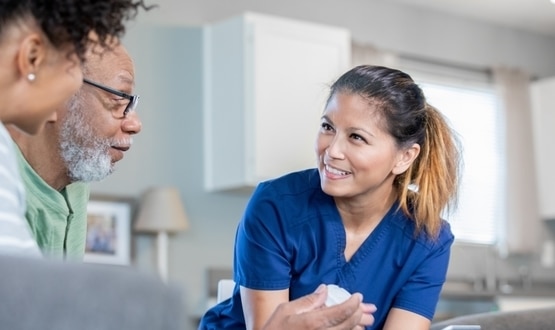 Nurse explains new medication to senior male in assisted living