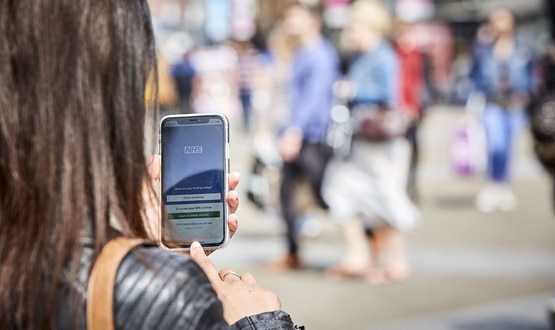 Woman using NHS App