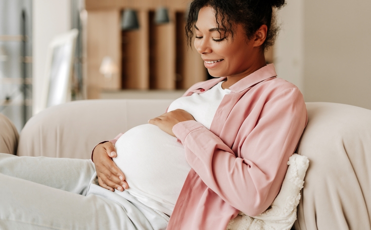 Pregnant,Woman,Is,Relaxing,On,A,Sofa,At,Home,,Gently