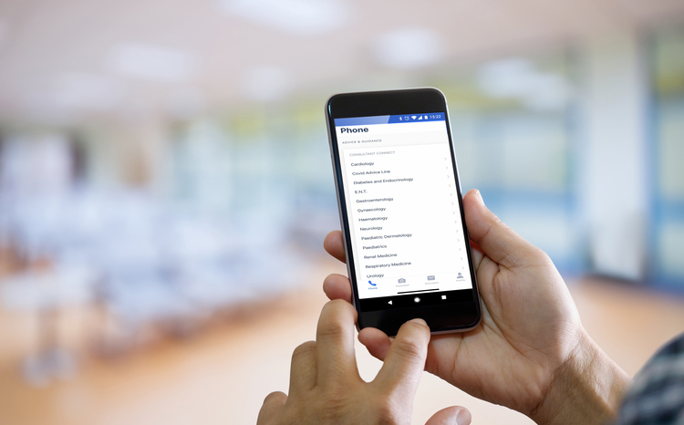 Healthcare professional using a mobile app to access specialist contact information and advice lines